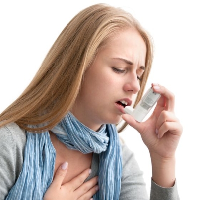 21817831 - young woman using an asthma inhaler as prevention