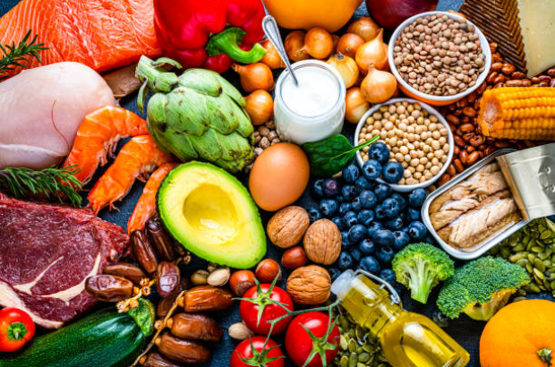 Overhead view of a large group of healthy raw food for flexitarian mediterranean diet. The composition includes salmon, chicken breast, canned tuna, cow steak,  fruits, vegetables, nuts, seeds, dairi products, olive oil, eggs and legumes. High resolution 42Mp studio digital capture taken with SONY A7rII and Zeiss Batis 40mm F2.0 CF lens