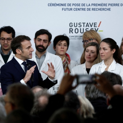 French President Emmanuel Macron (3rdL) delivers a speech during a ceremony to lay the first stone of the future research center as part of a visit at the Gustave Roussy Institute (IGR), a regional centre for the fight against cancer, on the occasion of World Cancer Day, in Villejuif, near Paris, on February 4, 2025. (Photo by Benoit Tessier / POOL / AFP)