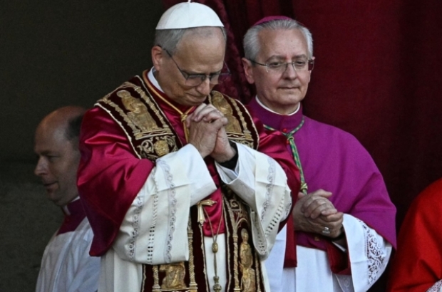 Newly elected Pope Leo XIV, Robert Francis Prevost (C) gestures as he addresses the crowd from the main central loggia balcony of the St Peter's Basilica for the first time, after the cardinals ended the conclave, in The Vatican, on May 8, 2025. Robert Francis Prevost was on Thursday elected the first pope from the United States, the Vatican announced. A moderate who was close to Pope Francis and spent years as a missionary in Peru, he becomes the Catholic Church's 267th pontiff, taking the papal name Leo XIV. (Photo by Gabriel BOUYS / AFP)