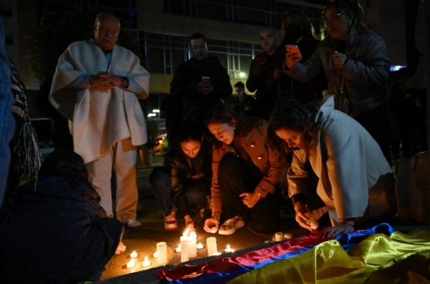 People light candles outside the Clinic Fundación Santa Fe, where Senator Miguel Uribe Turbay is receiving medical treatment after being shot and wounded in Bogota on June 7, 2025. A Colombian right-wing opposition senator and candidate for next year's presidential election, Miguel Uribe Turbay, 39, was shot and wounded in Bogota on June 7, 2025, various media reported, while the government denounced an "attack." (Photo by Raul ARBOLEDA / AFP)