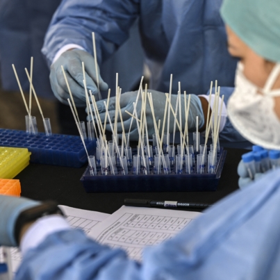 Medical personnel process the PCR tests against the COVID-19 virus taken from participants of the Iran-Venezuela Industrial Scientific and Technological Expoferia prior to the opening ceremony in Caracas, on September 15, 2022. More than 80 Iranian companies are participating in the fair together with some three hundred Venezuelan companies that have requested their participation in the event that takes place from September 15 to 19. (Photo by Yuri CORTEZ / AFP)